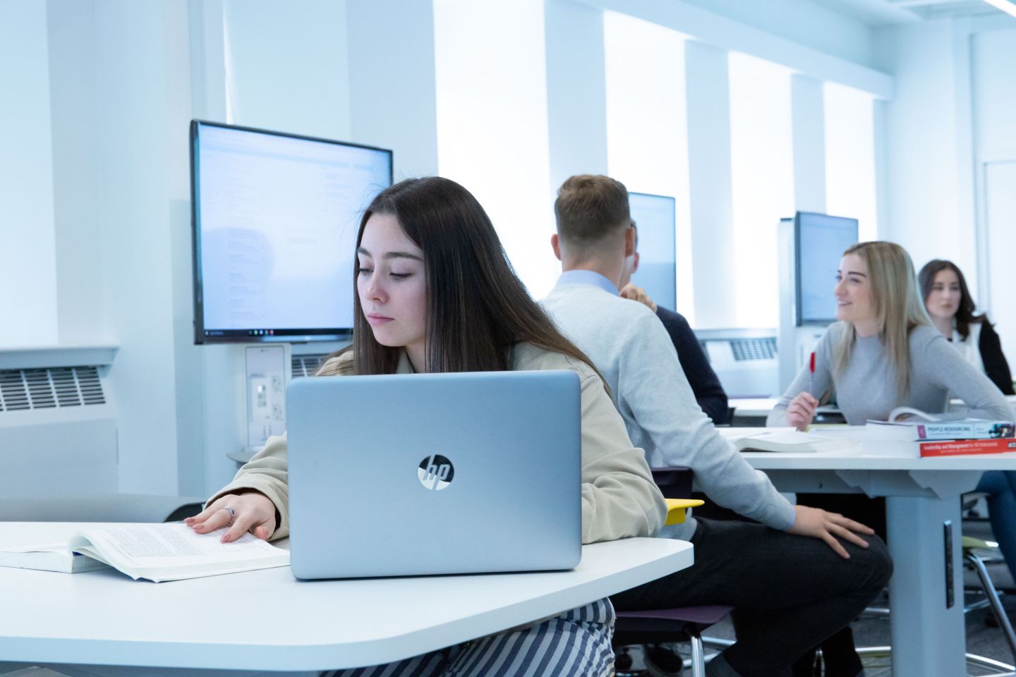 BA (Hons) Business Management and BA (Hons) International Business students working in classroom at Glasgow Caledonian University