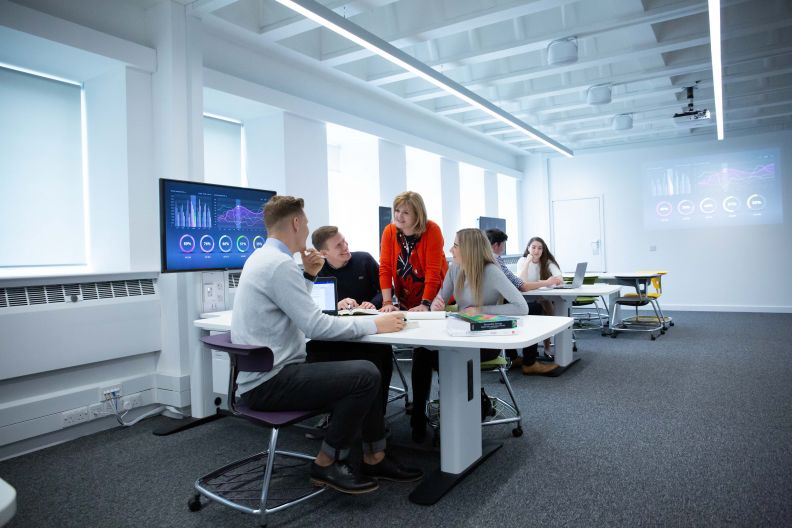 BA (Hons) Business Management and BA (Hons) International Business lecturer and students in classroom at Glasgow Caledonian University