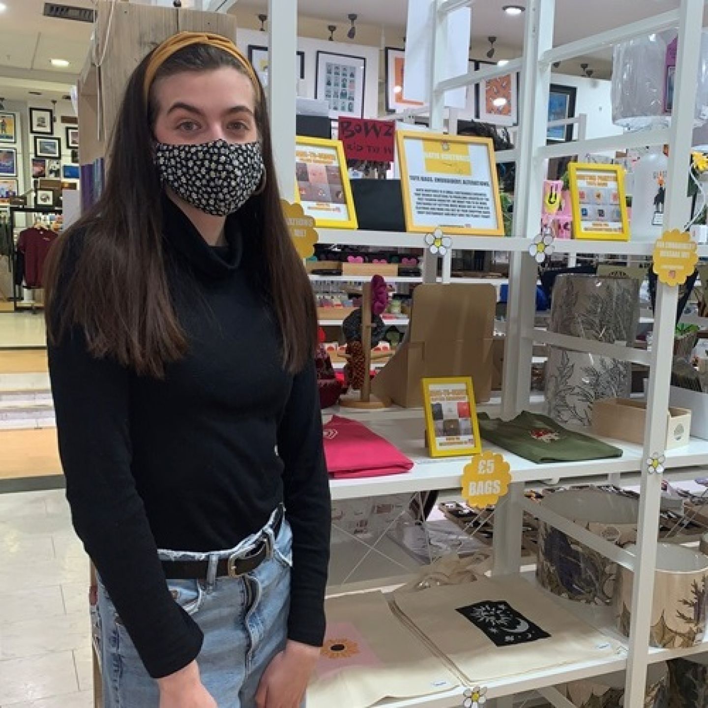 GCU student and Santander Magnusson Award winner 2022 in front of products in her sustainable fashion business.