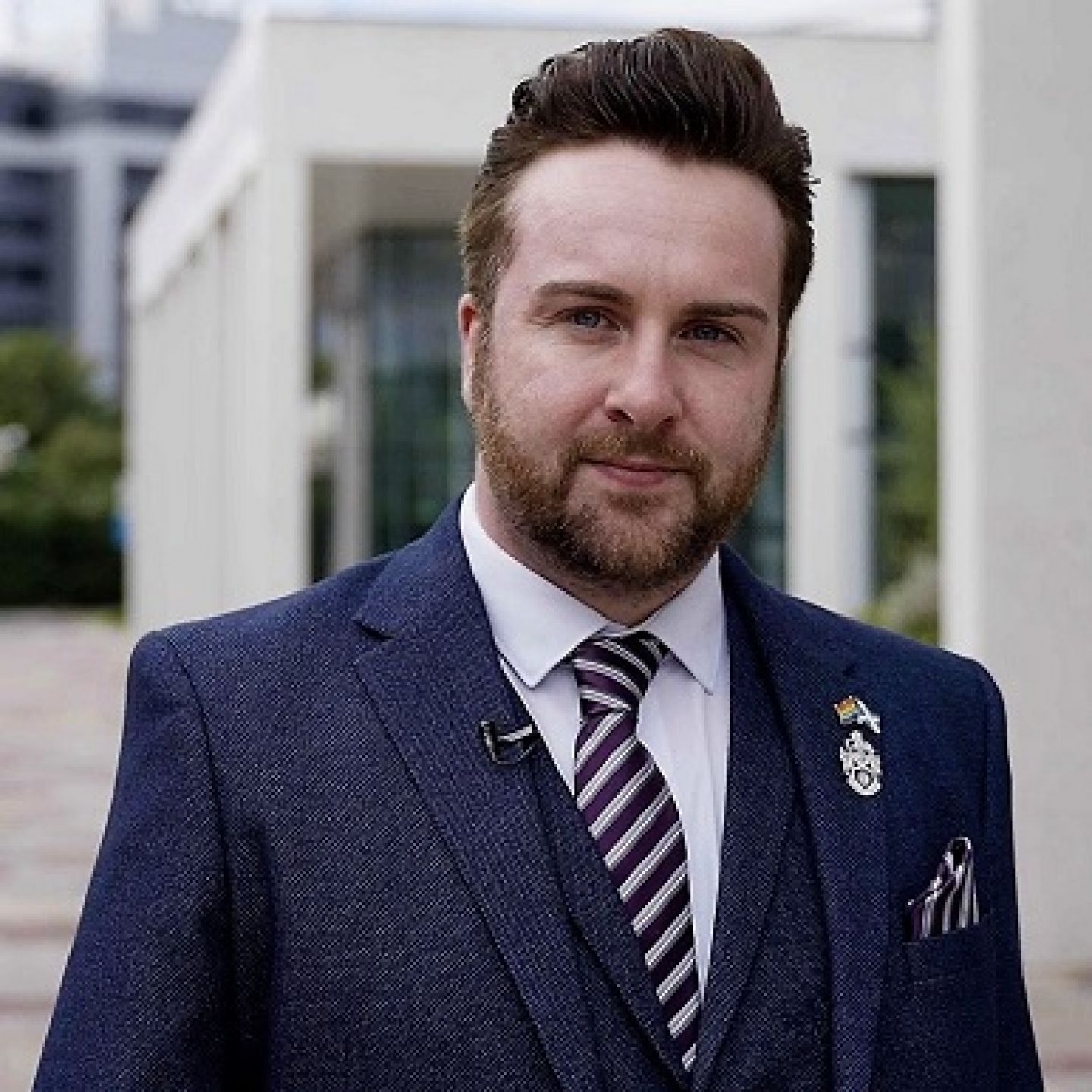 A square image of Ross McGhee, a GCU alumnus and President of the Society of Radiographers 2022/23, in front of building in the GCU Glasgow campus.