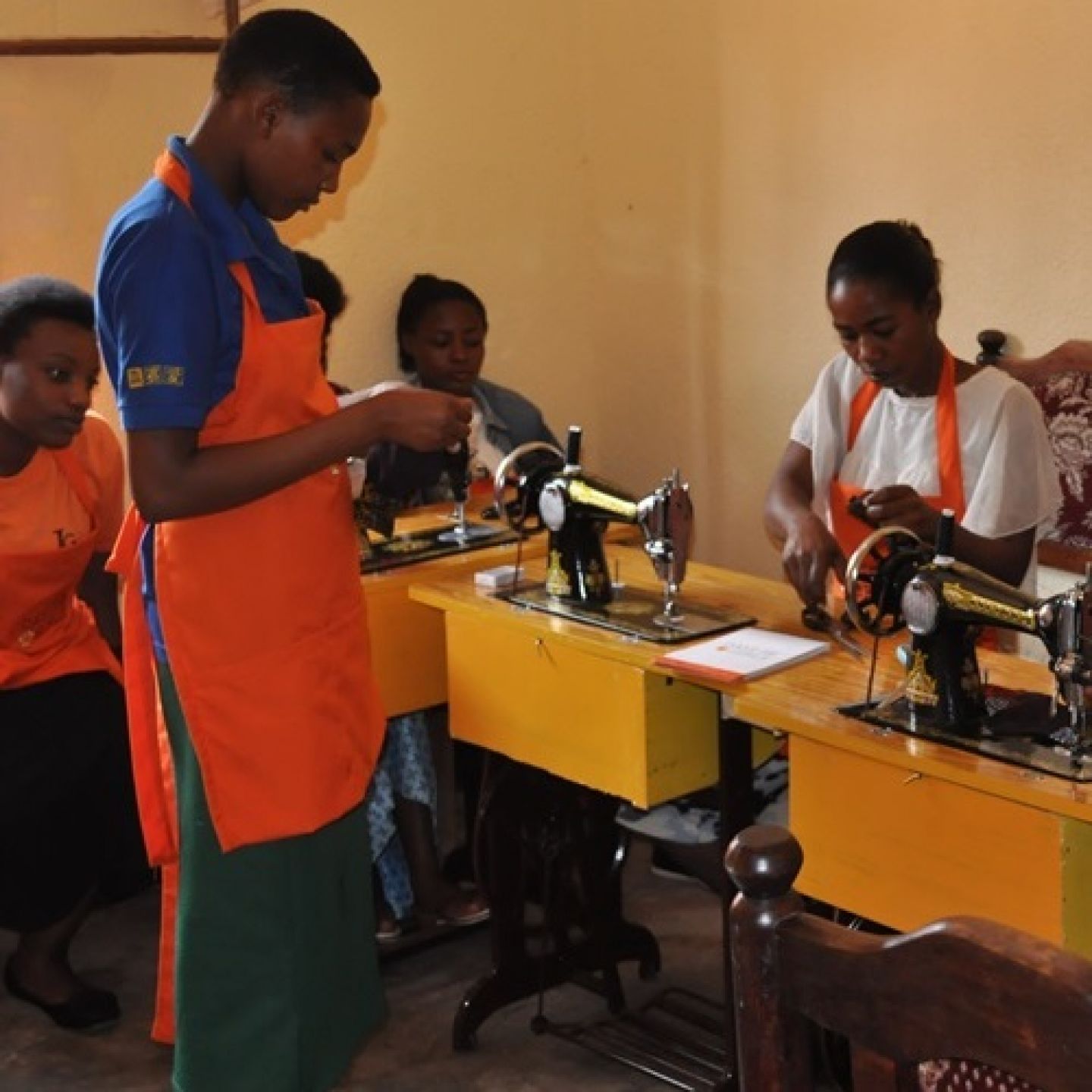 An image of Rwandan women sewing in a Rwandan classroom.