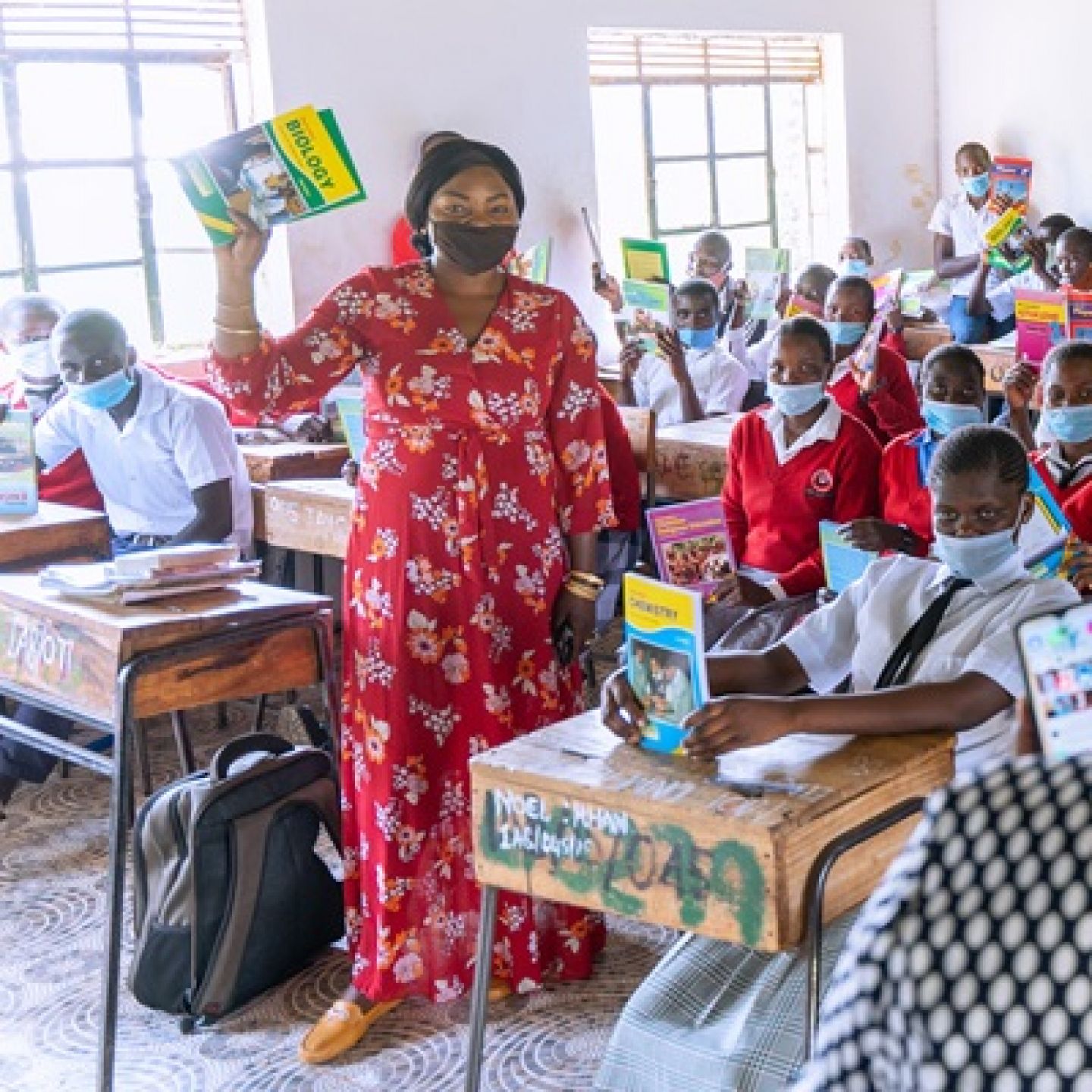 GCU graduate and 2021 Magnusson Award winner Tabitha Nyariki, with students in a classroom of Imprezza Academy in Kenya that she helped rebuild and restock the school library.