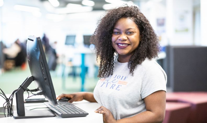 Undergraduate student using a computer on campus