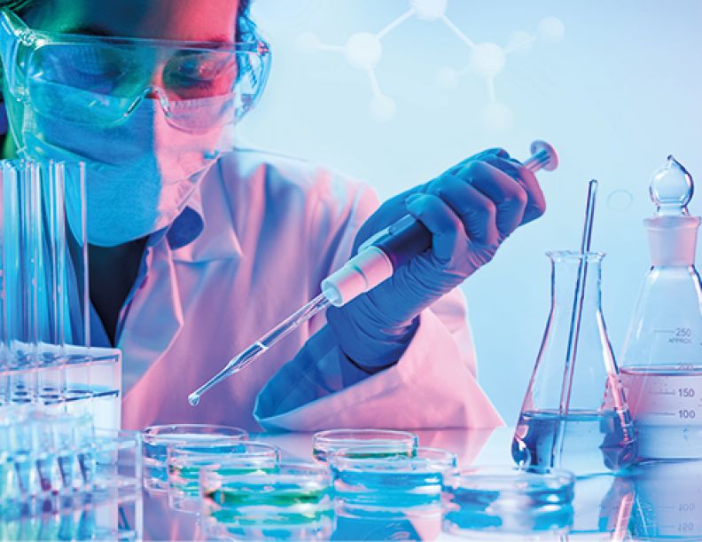 Female Student working in lab/goggles/face mask