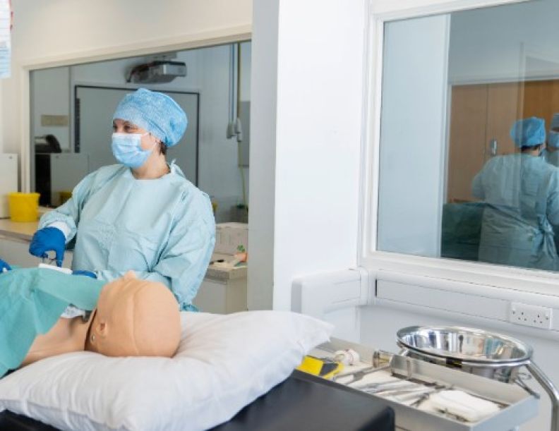 Students attending to manikin