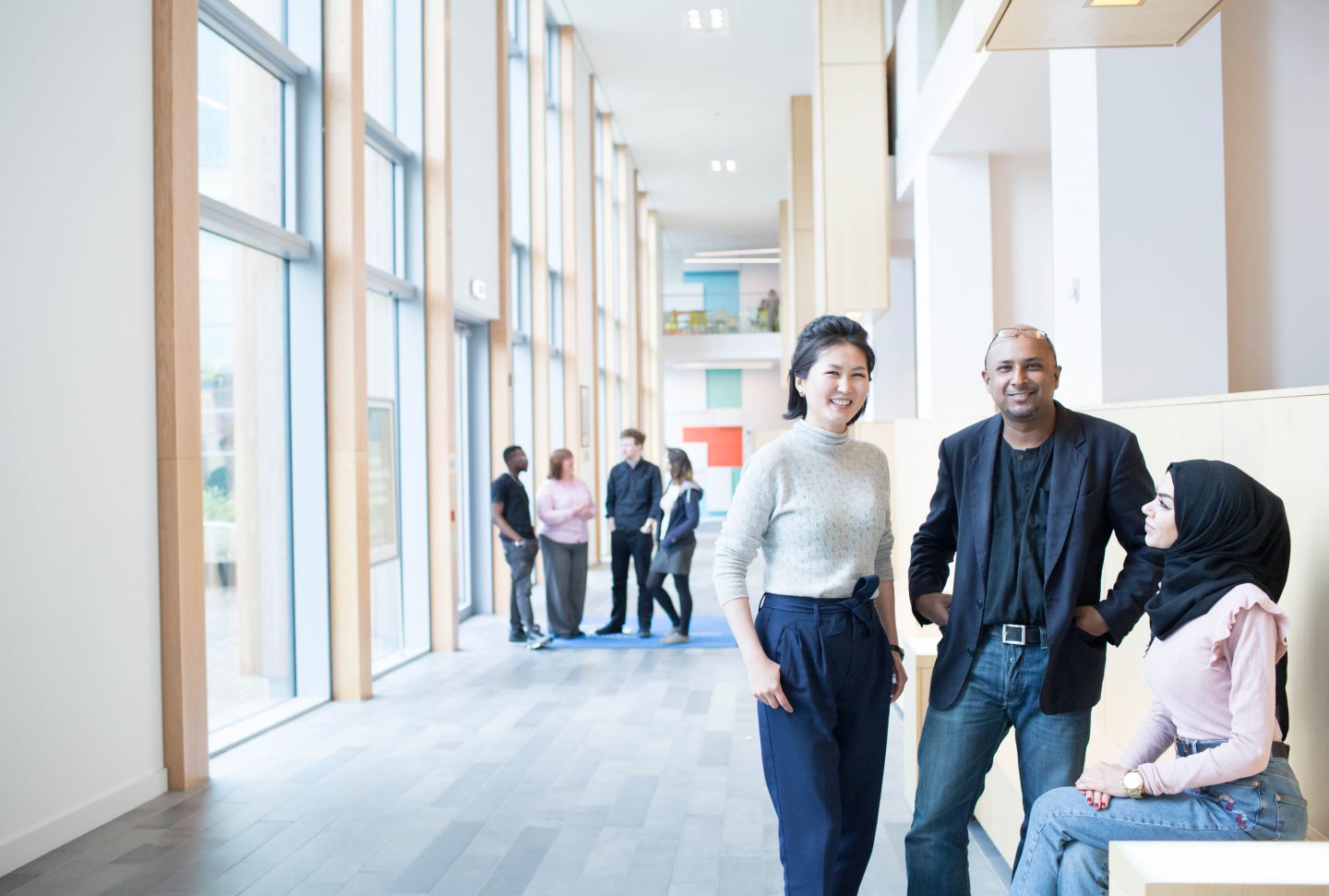 Students standing in corridor walkway on campus at Glasgow Caledonian University