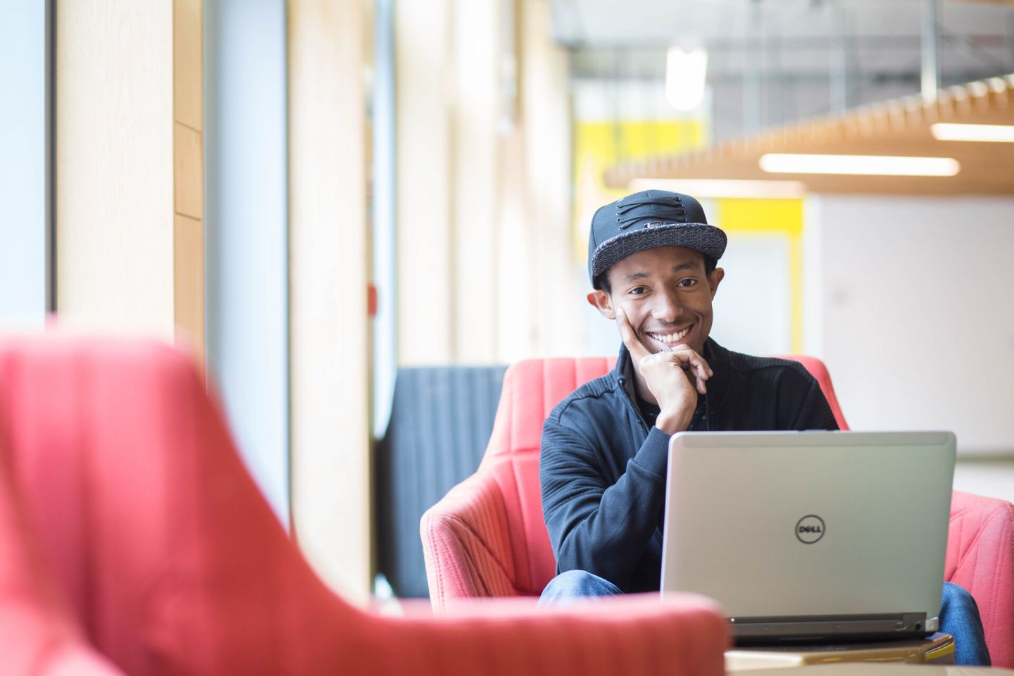 International student sitting with laptop on GCU campus