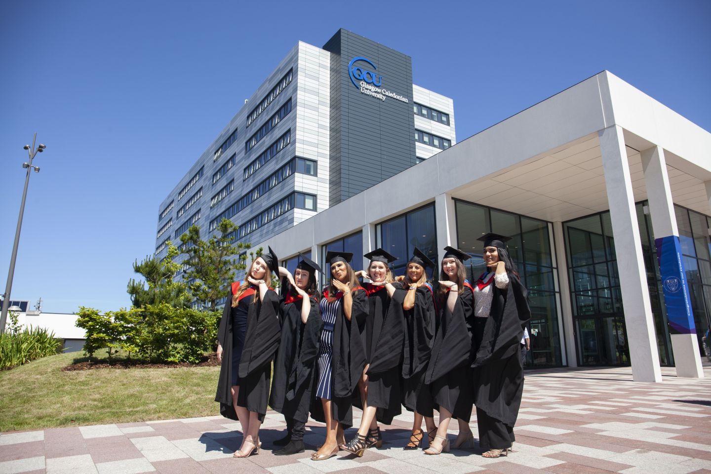 Students pose on graduation day at Glasgow Caledonian University.