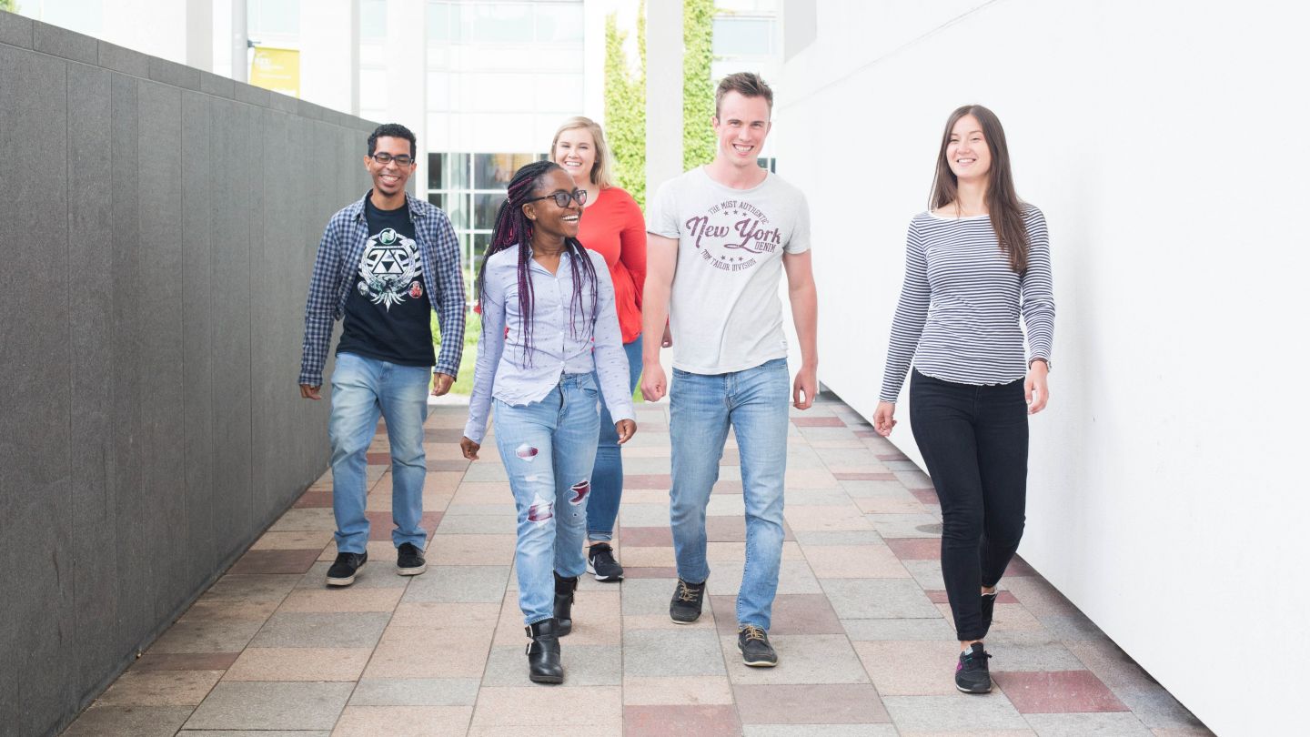 Students walking on campus at Glasgow Caledonian University