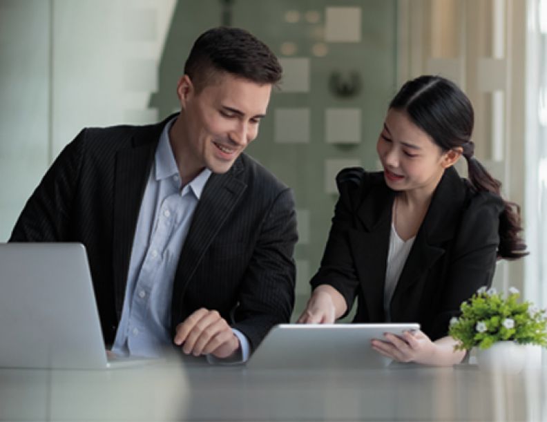 Male and female sharing laptop