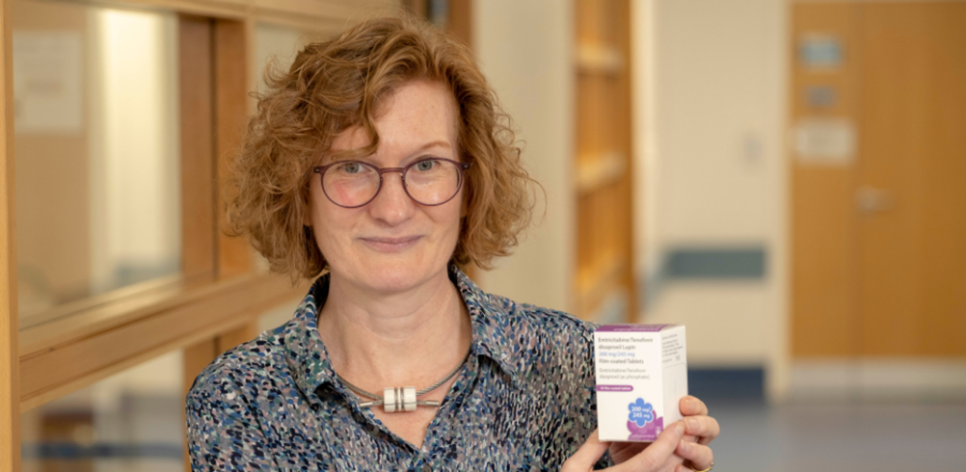 GCU Professor of Sexual Health and HIV Claudia Estcourt holding a pack of PrEP