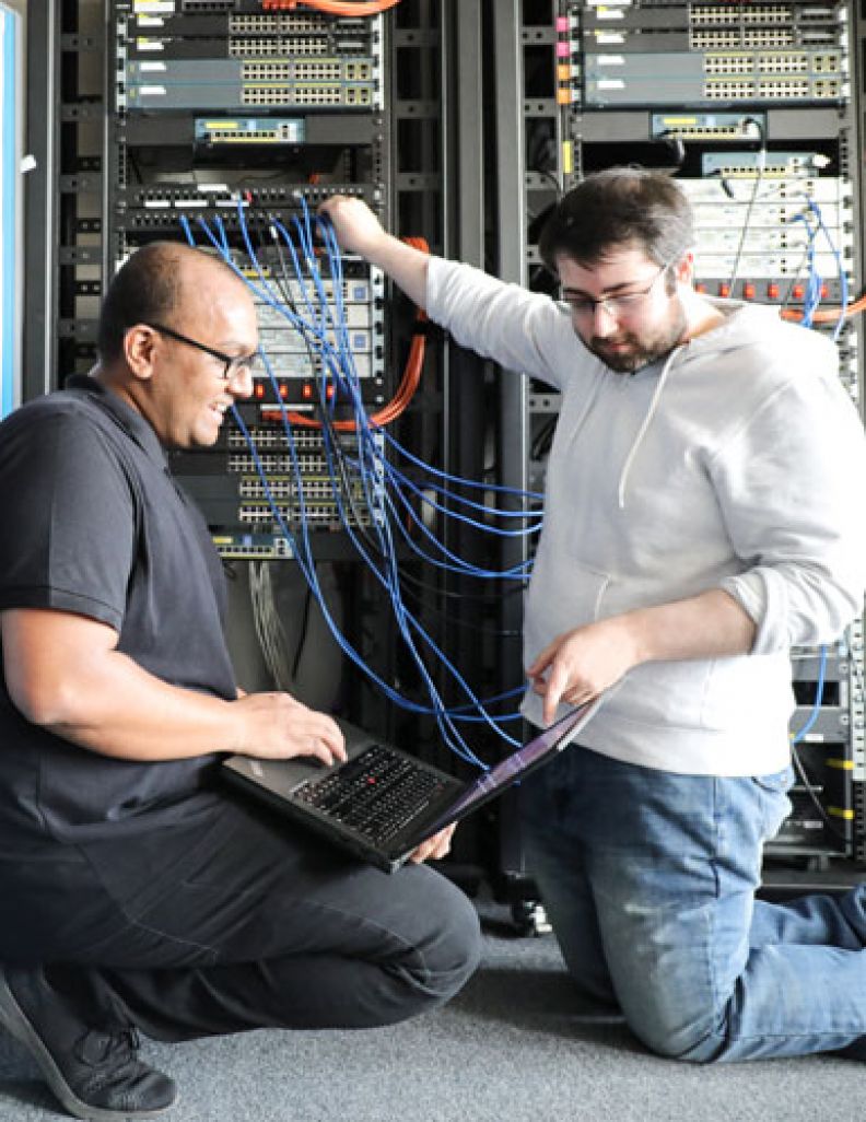 Cyber security student working with tutor in a computer lab