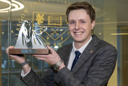GCU Alumnus and GCU Alumni of the Year (AOTY) winner Andrew Wilson holding his AOTY award GGCU Alumnus and GCU Alumni of the Year (AOTY) winner Andrew Wilson holding his AOTY award
