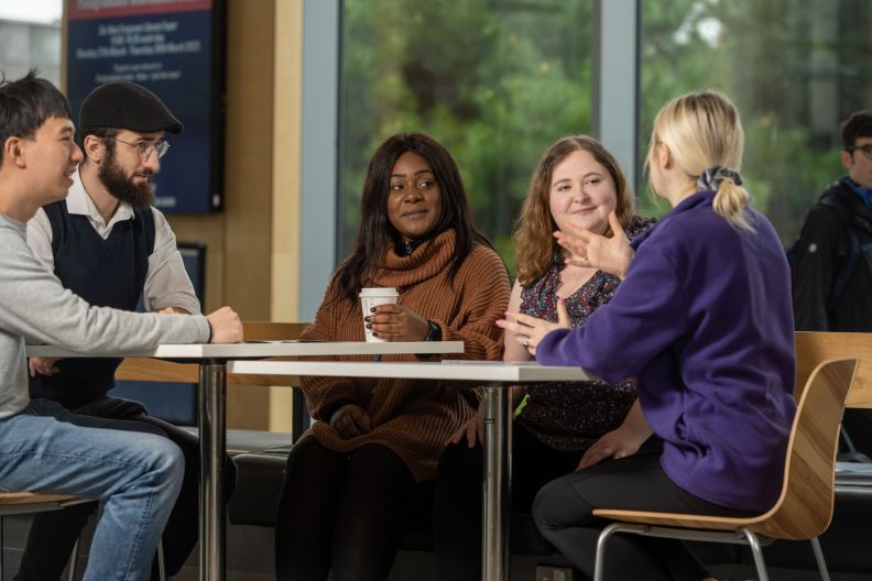 Four potential postgraduate students at a GCU opening evening