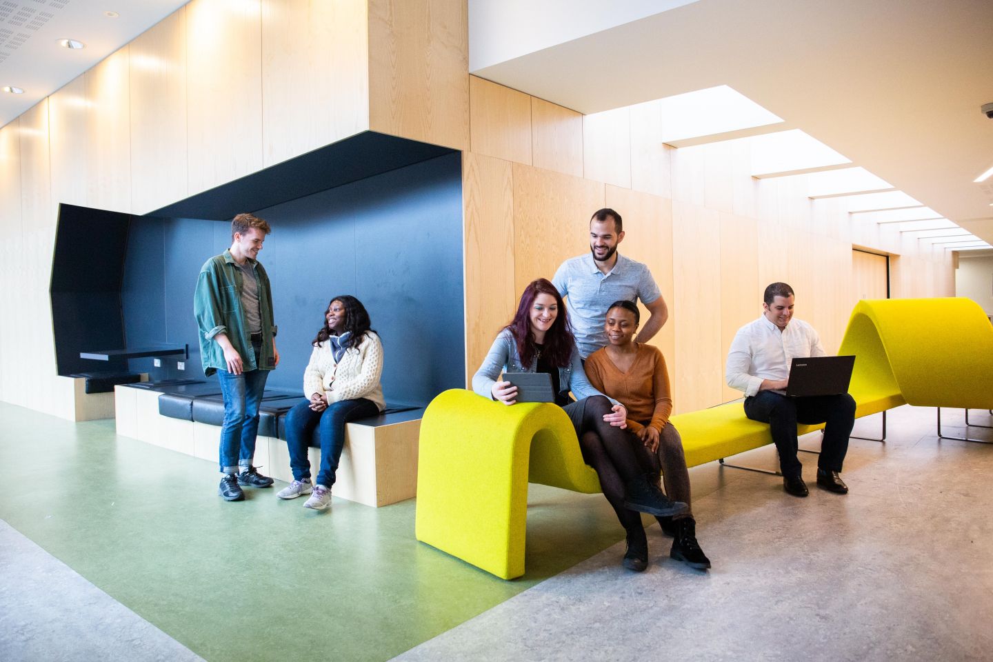 Postgraduate students on the sofas in the George Moore building