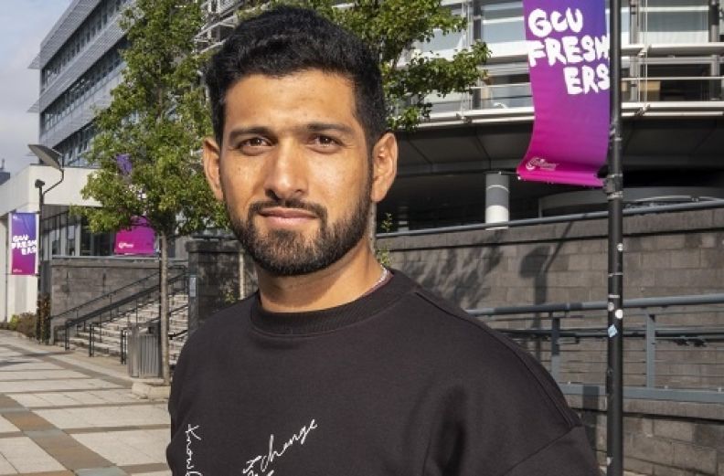 A profile picture of Sikandar Raza, a GCU alumnus and an international cricketer, in the exterior of Glasgow campus.