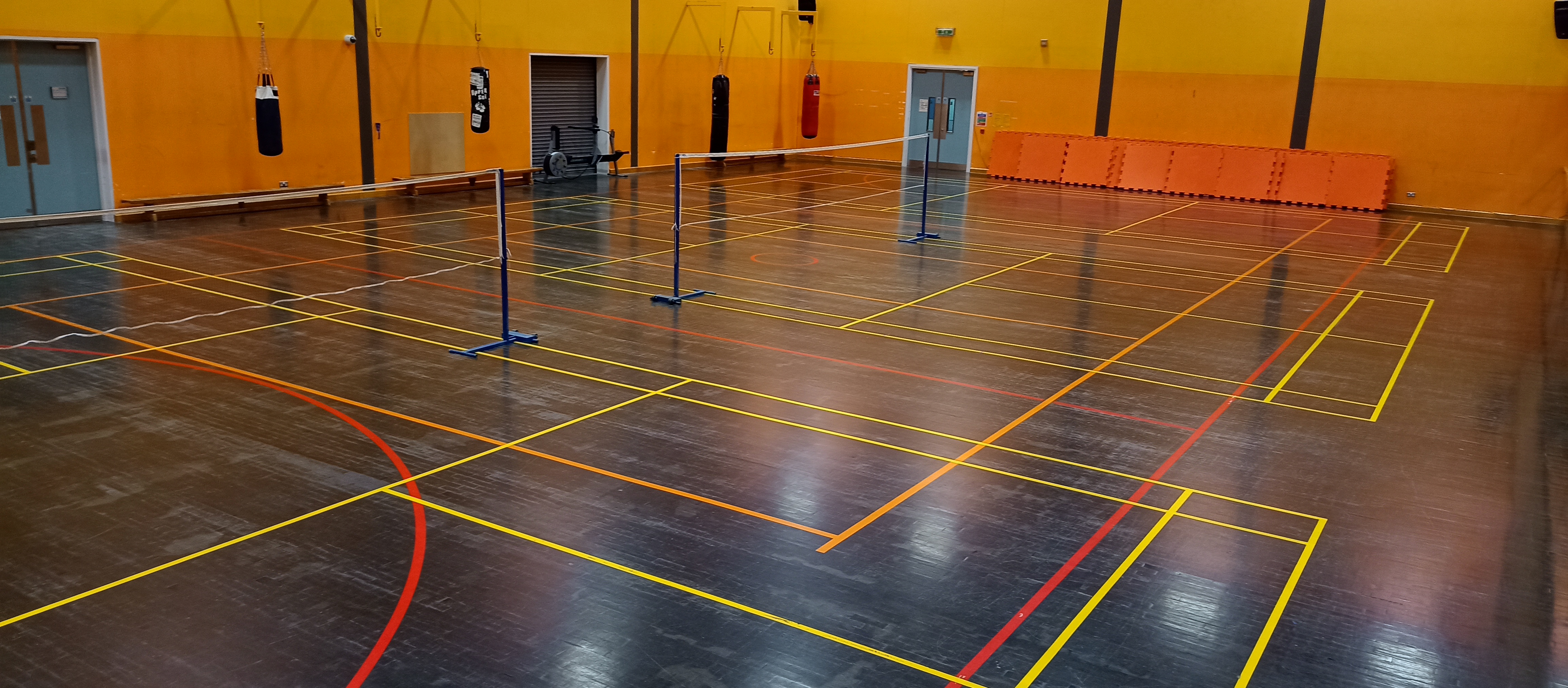 The small hall in the ARC building with badminton set up.