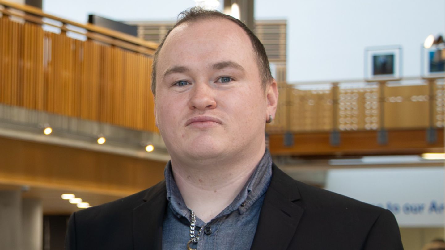 A photo of Grant McAdam on the ground floor of the Sir Alex Ferguson Library