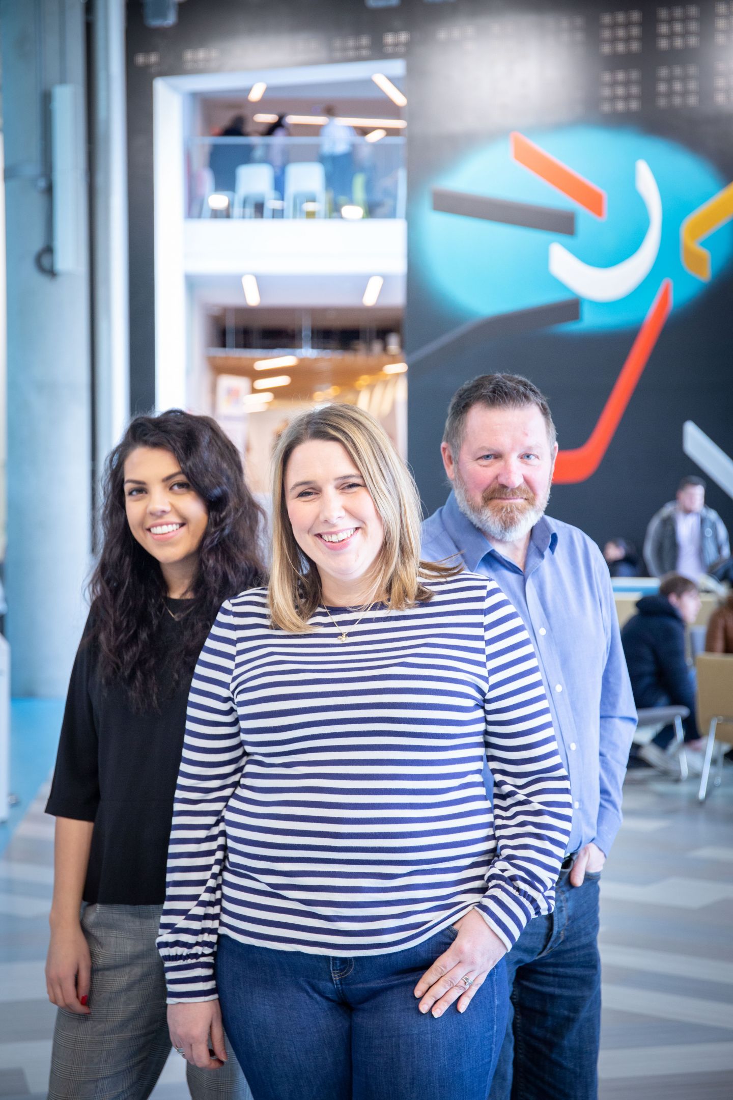 Staff members Kirsty MacInnes, Rebecca Meechan and Frank Brown in the Sir Alex Ferguson Library foyer.