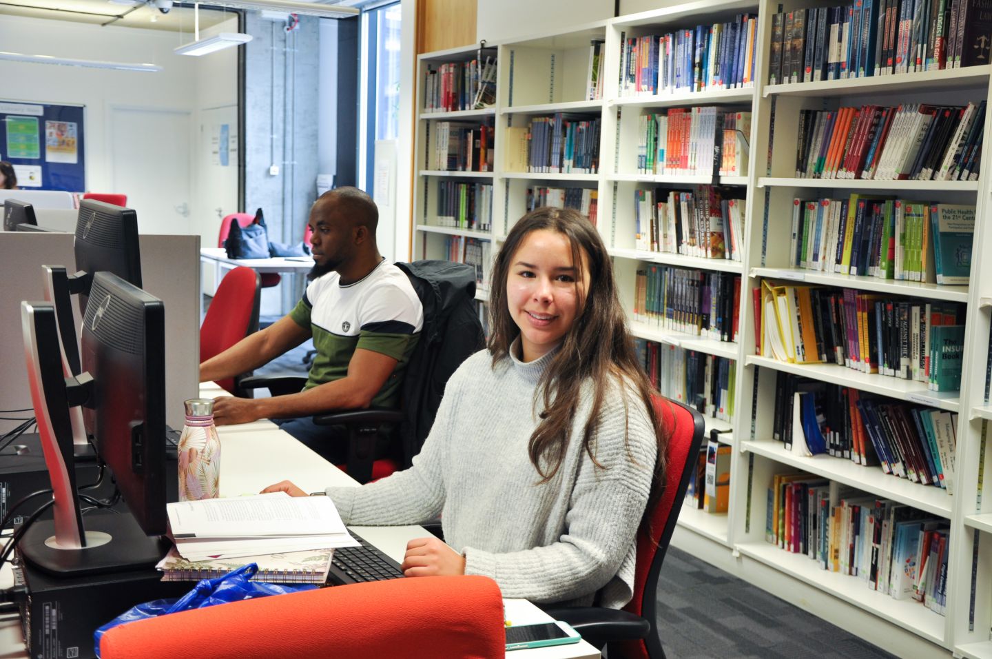 GCU London students in the library on campus in March 2020, studying while using the computers