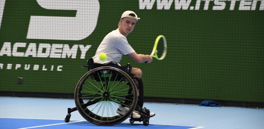 Thomas playing wheelchair tennis