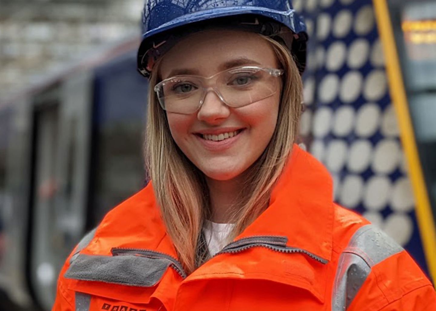 Headshot of Sarah Speirs, a civil engineering graduate apprentice, wearing a hard hat and high vis jacket