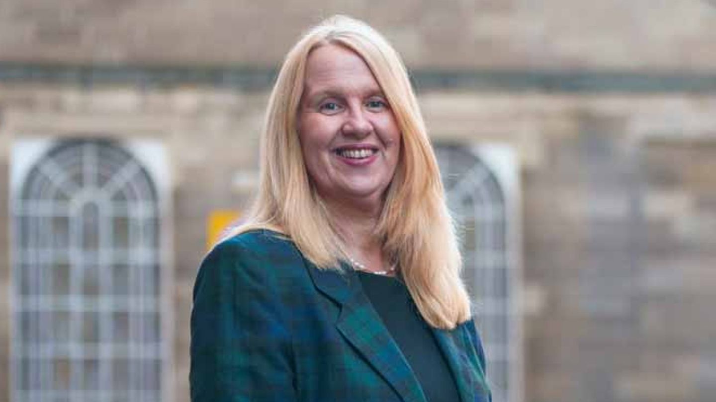 A photo of Professor Elaine Boyd OBE standing outside smiling